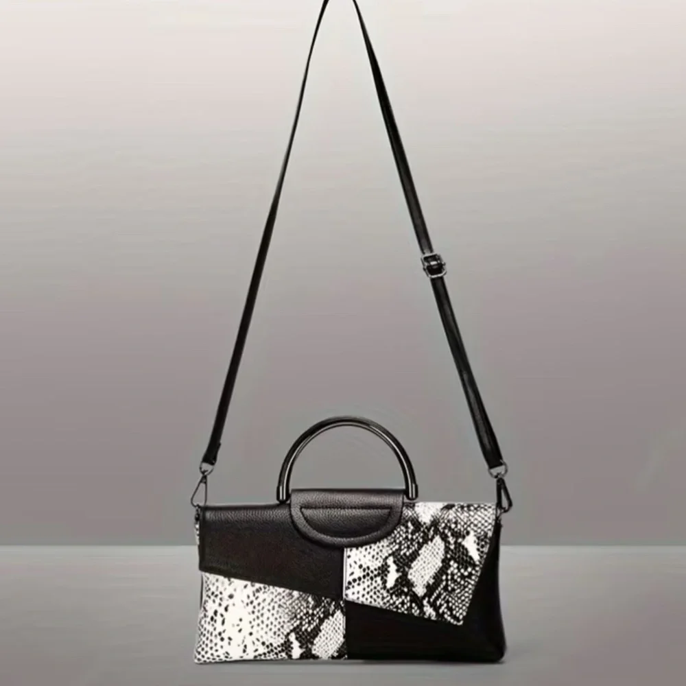 Luce black and white snakeskin clutch bag